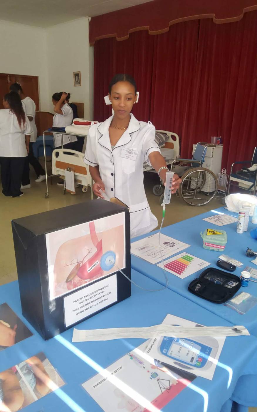 Student demonstrating PEG tube feeding